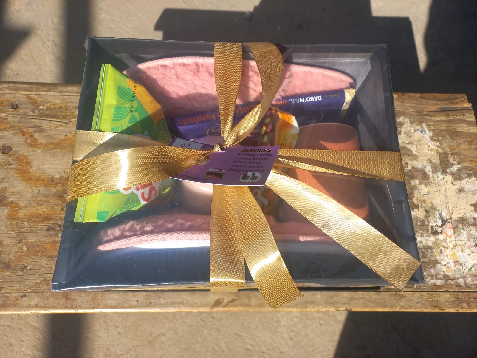 Premium gift hamper wrapped with gold ribbon