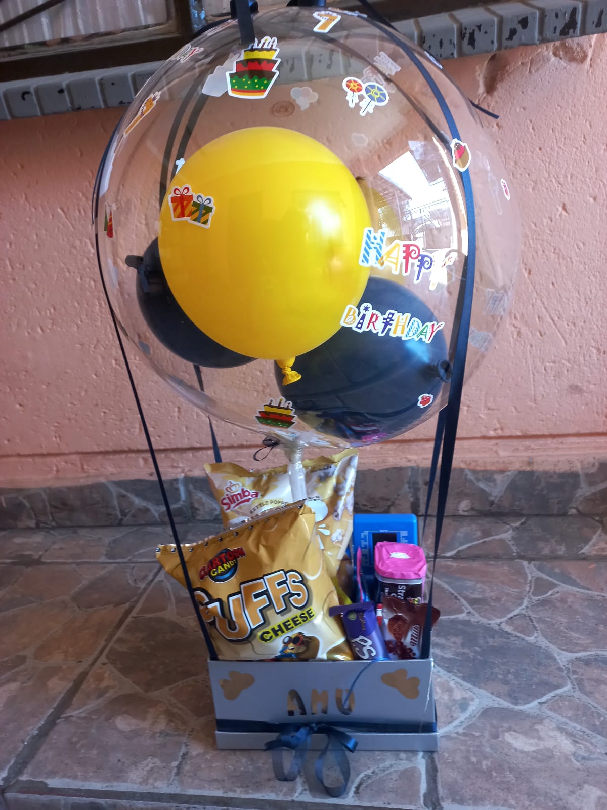Yellow balloon snack hamper with chocolates and chips