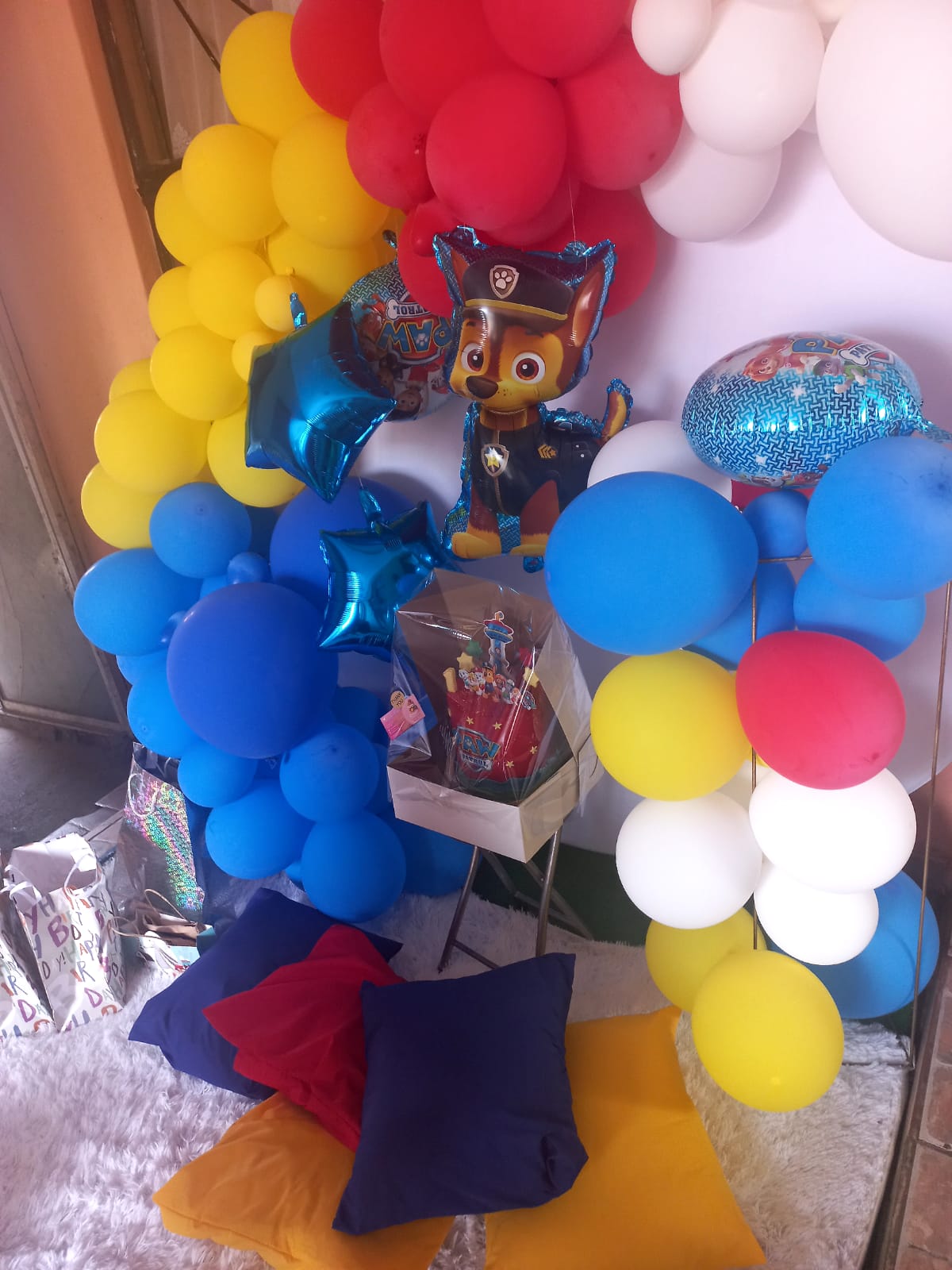 Colourful Paw Patrol balloon arch with cushions for kids party
