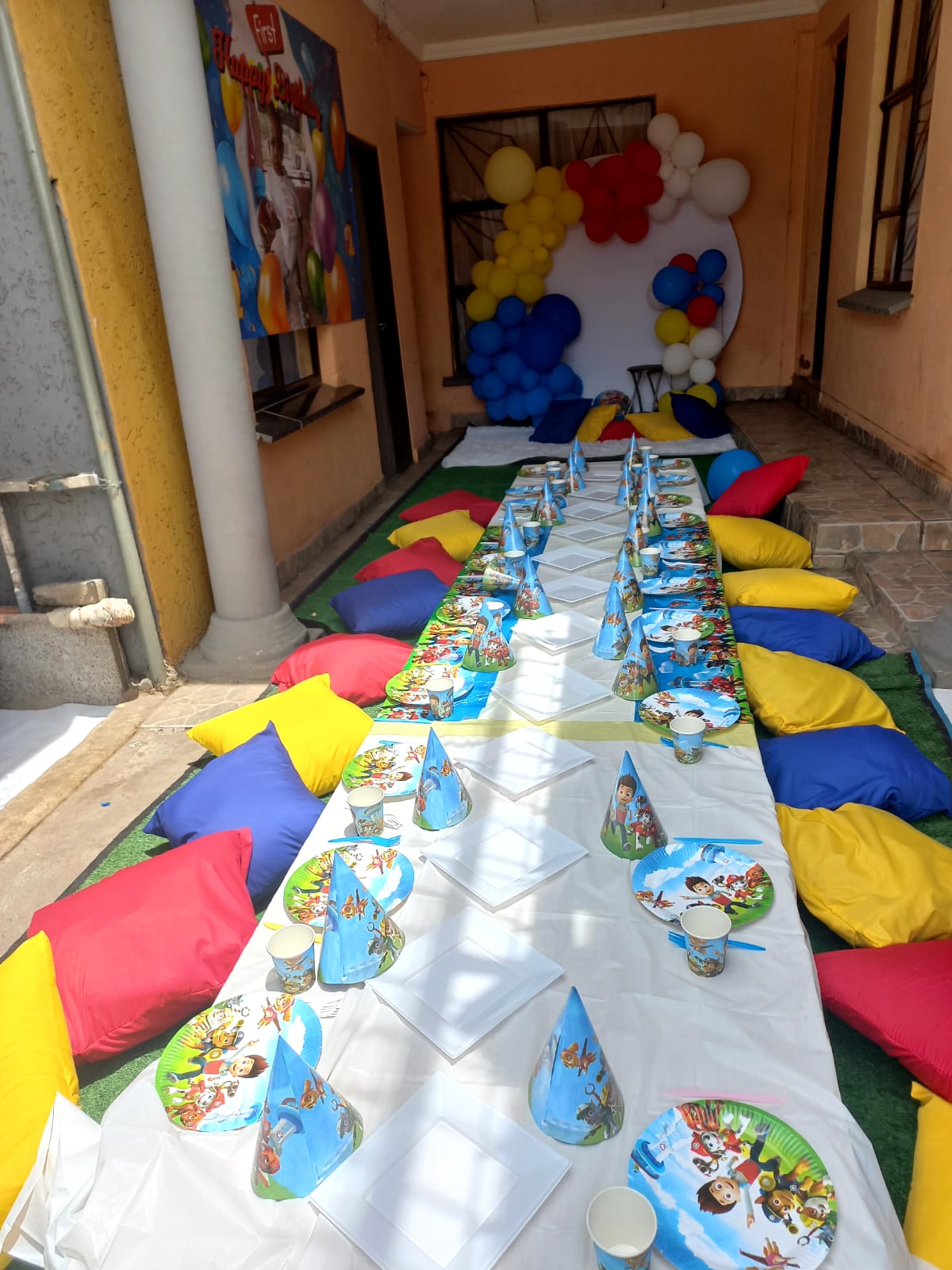 Paw Patrol themed kids party long table setup with cushions